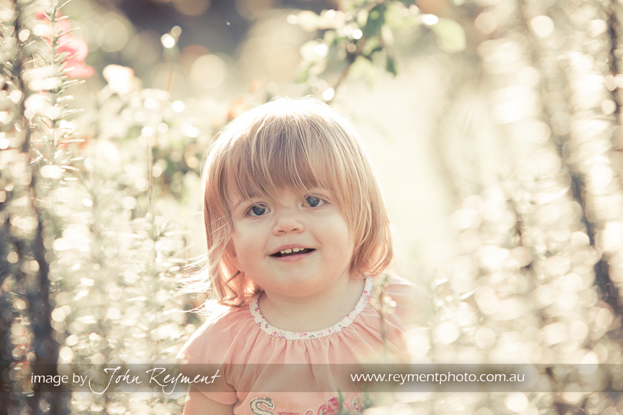 Claire amongst the roses in New Farm Park, by Brisbane family portrait photographer John Reyment