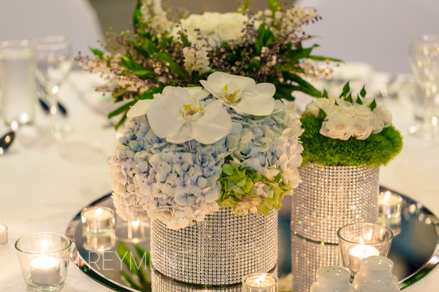 Floral centrepieces in Barrel Hall, Sirromet Winery by Brisbane wedding photographer John Reyment