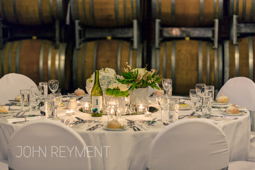 Floral centrepieces in Barrel Hall, Sirromet Winery by Brisbane wedding photographer John Reyment